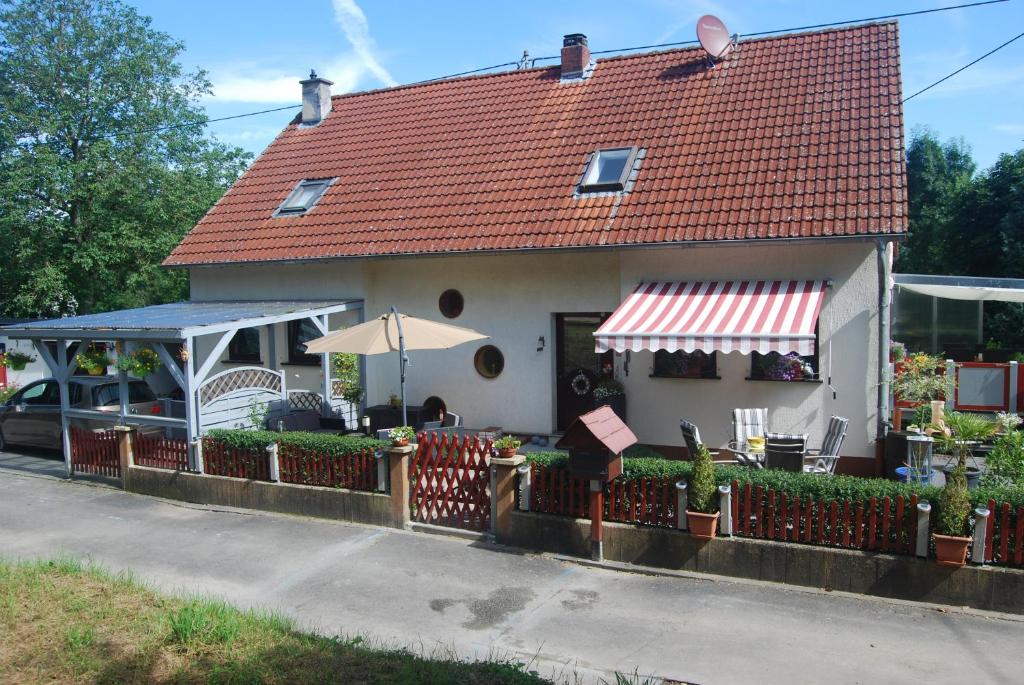 杜德尔多夫Ferienwohnung Cillien的一座红色屋顶和围栏的房子