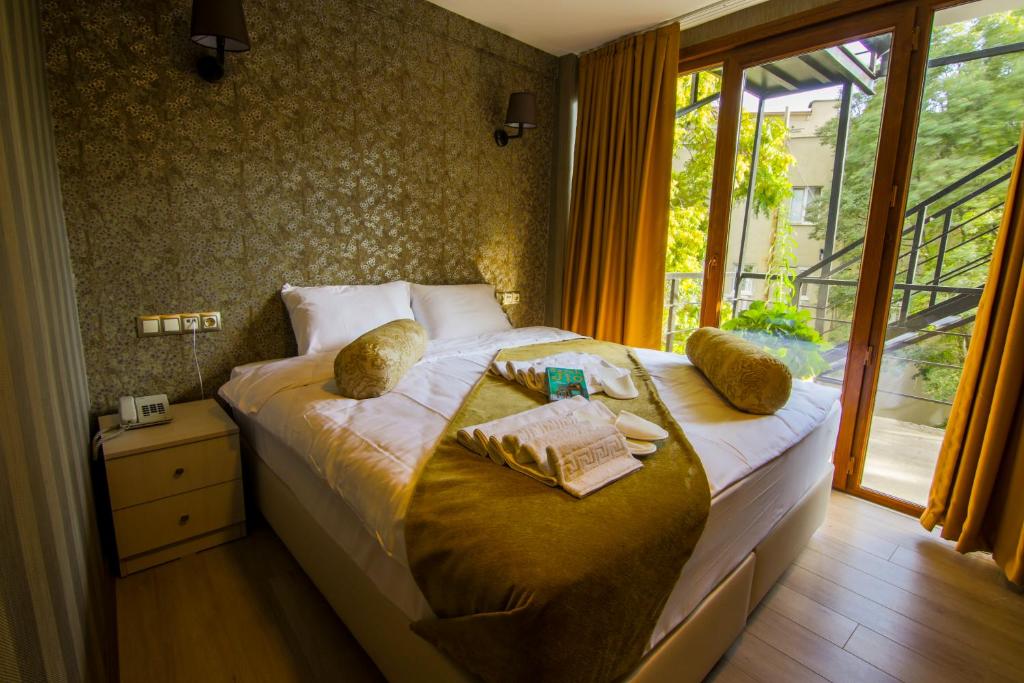 伊斯坦布尔库曾酒店的一间卧室设有一张大床和窗户