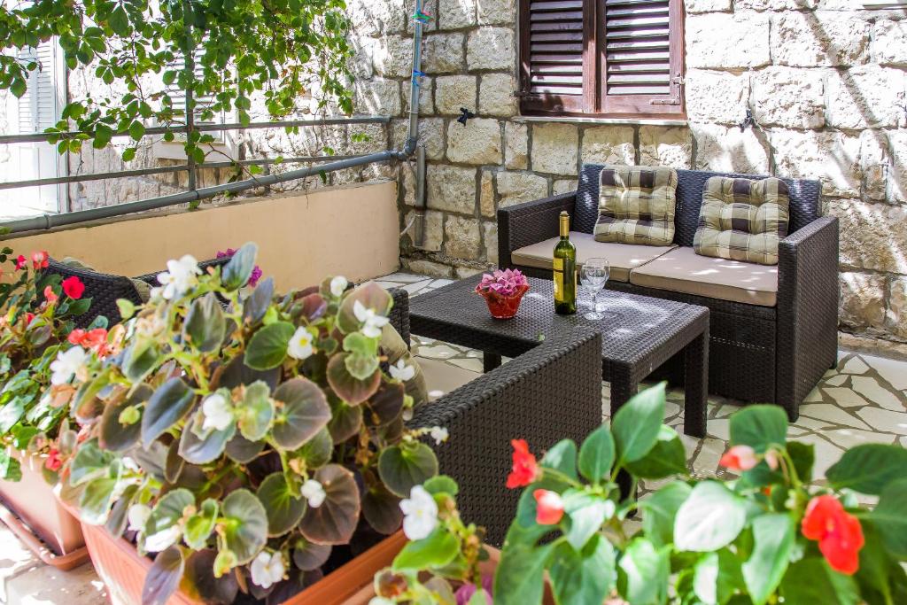特雷斯塔尼克Ante Apartments的天井配有桌椅和盆栽植物