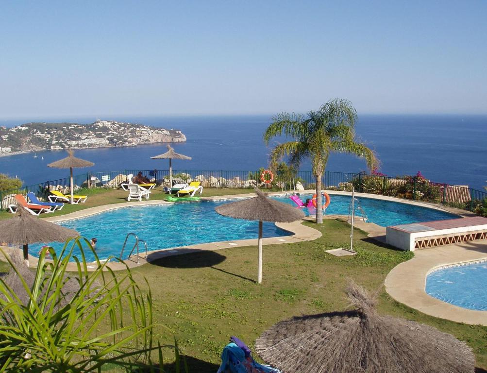 拉海瑞德拉Casa José的一座带遮阳伞的游泳池,其背景是大海