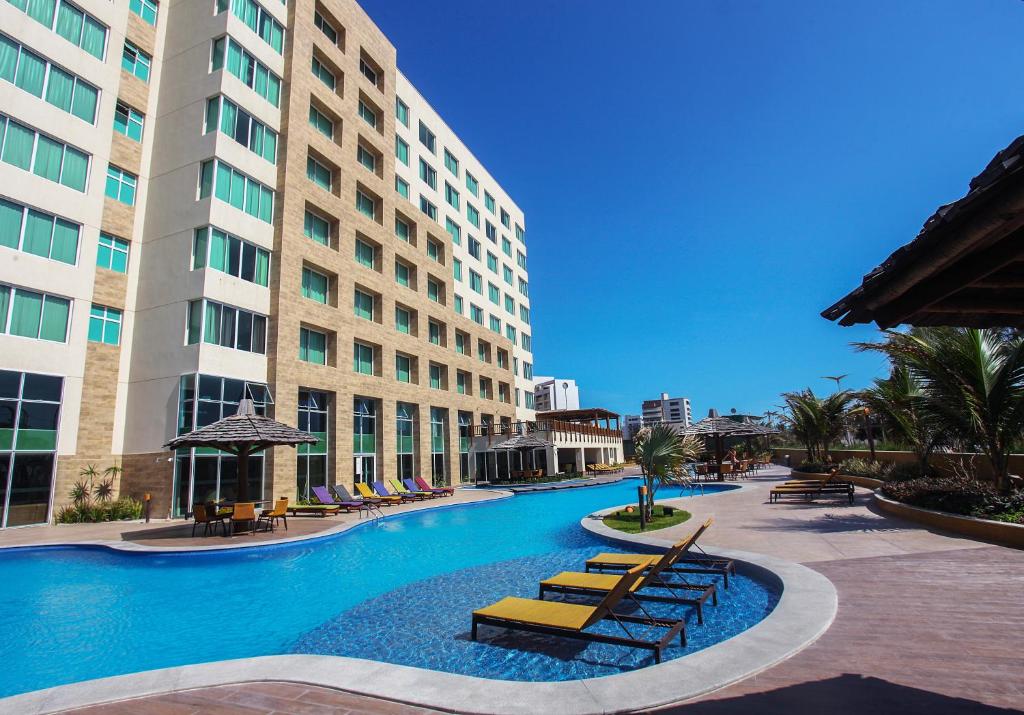福塔莱萨豪华马雷洛酒店的一座大建筑前的游泳池
