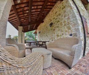 SantʼUrbanoAgriturismo Isola Verde的庭院配有3把藤椅和桌子