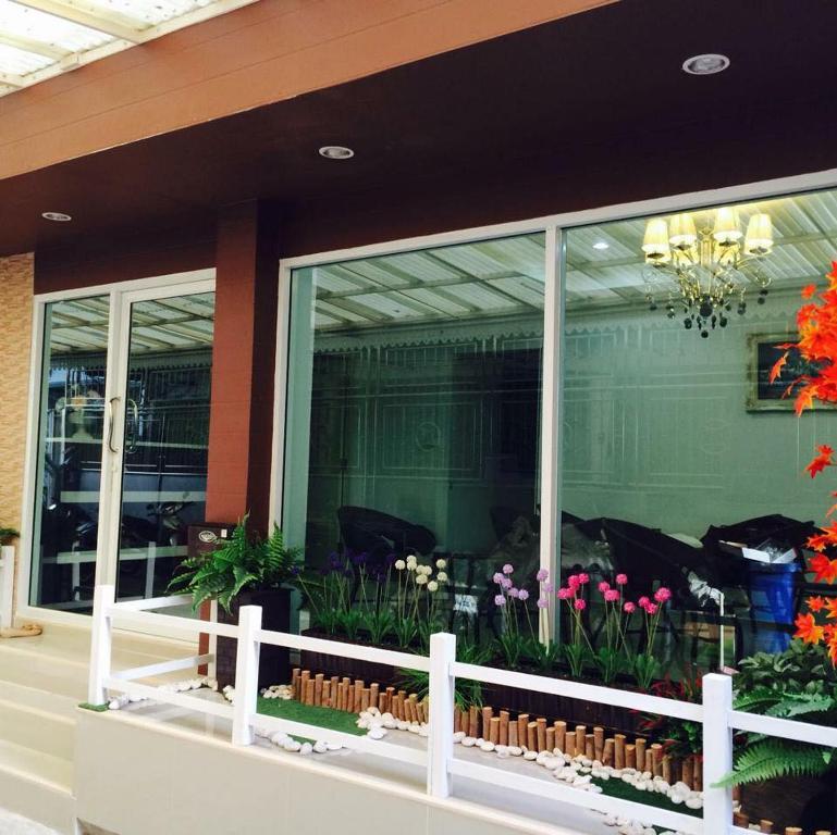 曼谷Bann Bunga Inn的橱窗里鲜花盛开的商店前