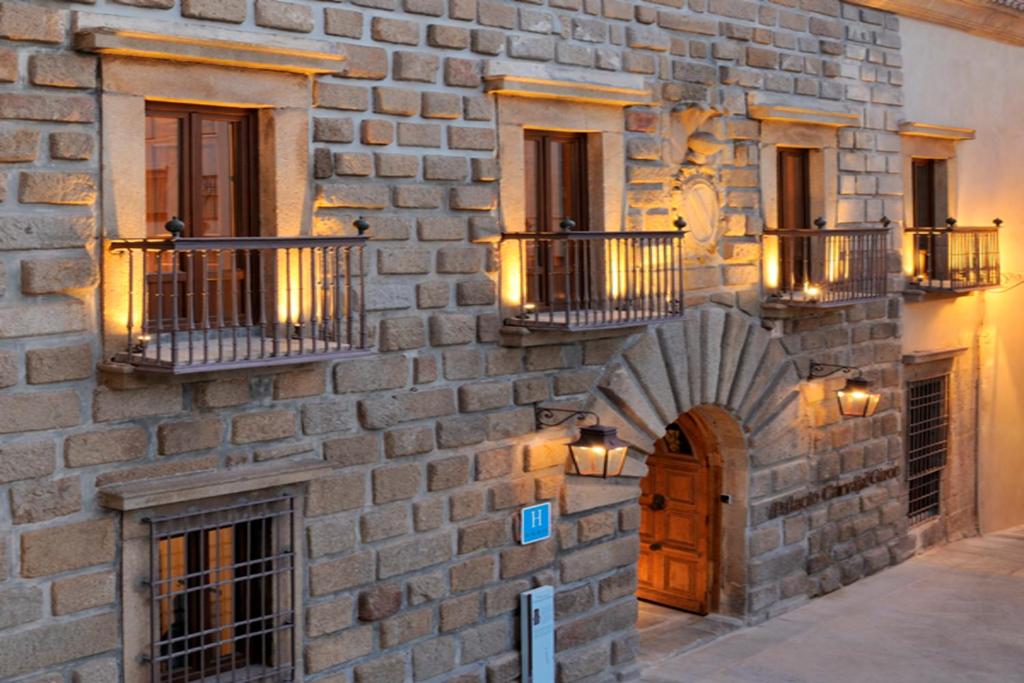 普拉森西亚卡瓦哈尔吉隆宫酒店的砖砌的建筑,上面有门和阳台