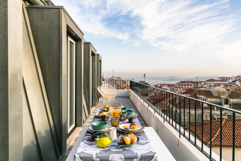 里斯本希亚多阿尔梅利亚珍藏公寓的阳台上的桌子上放着食物