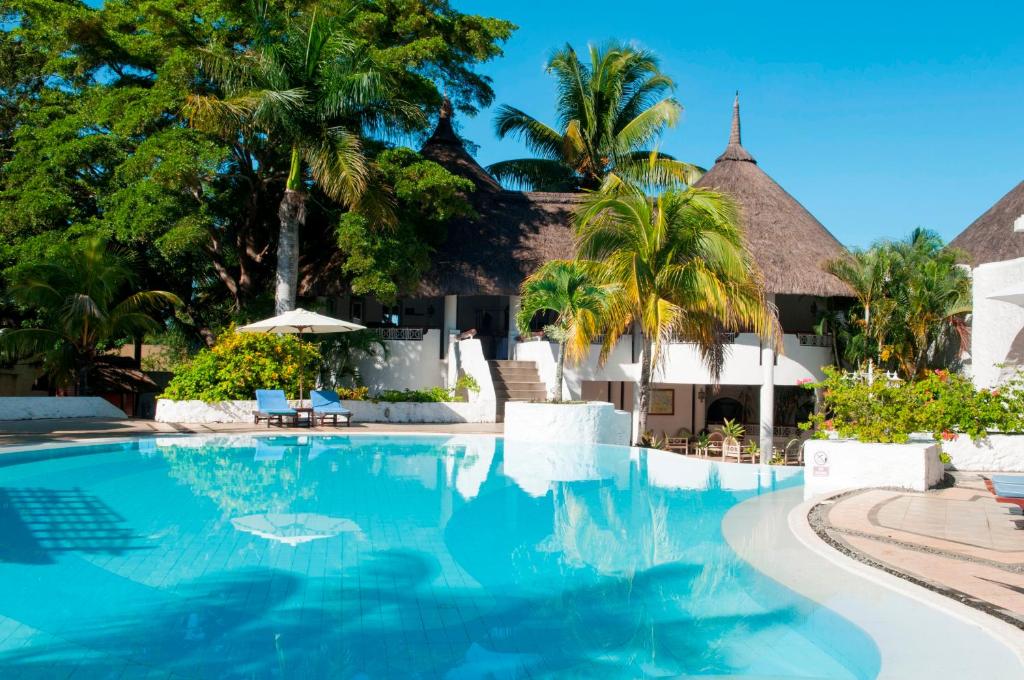 特鲁欧克比赫斯木麻黄度假酒店的棕榈树度假村前的游泳池