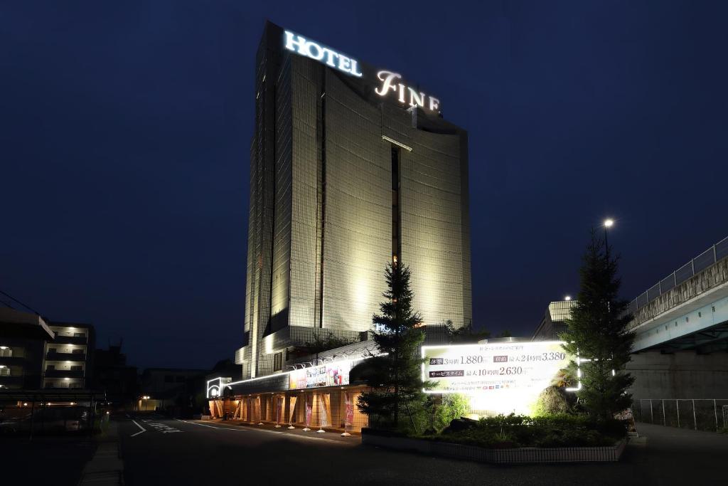 栗东Hotel Fine Shiga Ritto的夜间标有标志的酒店大楼