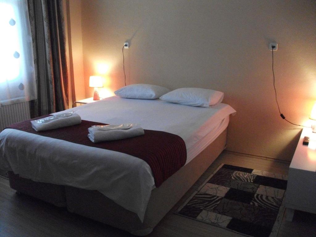 恰纳卡莱厄尔努尔旅馆的一间卧室配有一张床,上面有两条毛巾
