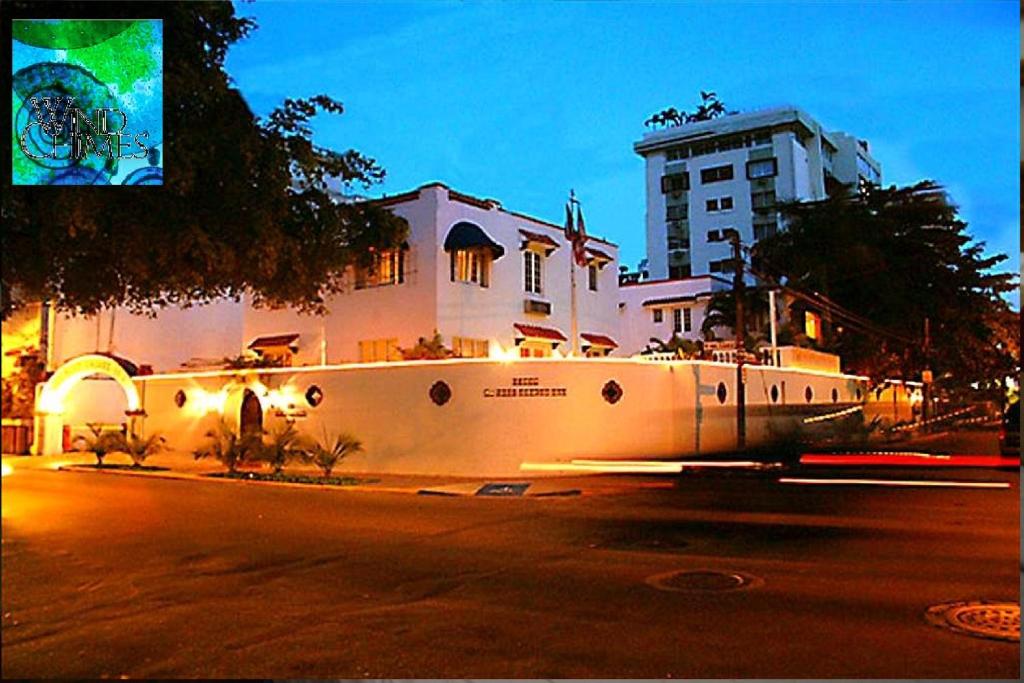 圣胡安风铃精品酒店 的街道边有白色墙壁的建筑
