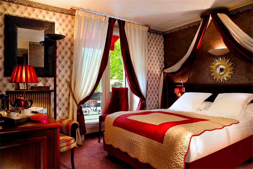 巴黎布里坦尼克酒店的一间卧室配有一张床、一张书桌和一个窗户。