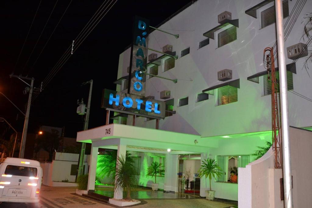 Paraguaçu PaulistaDmarco Hotel的前面有 ⁇ 虹灯标志的酒店