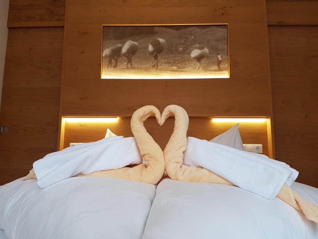 圣瓦伦蒂诺阿拉穆塔apartments Monika的床上的枕头制成的两天鹅