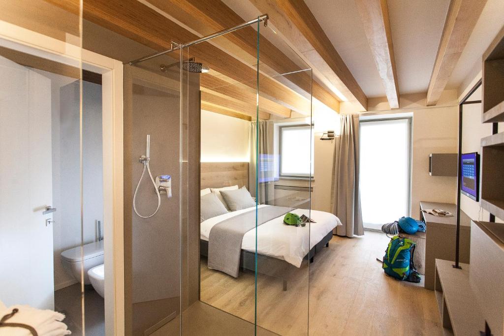 阿科Casa Alla Lega的一间卧室设有一张床和一个玻璃淋浴间