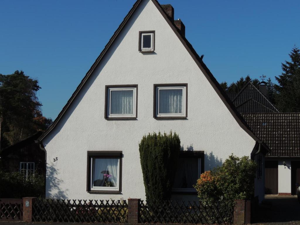 施内沃丁根Ferienhaus Snevern的黑色屋顶的白色房子