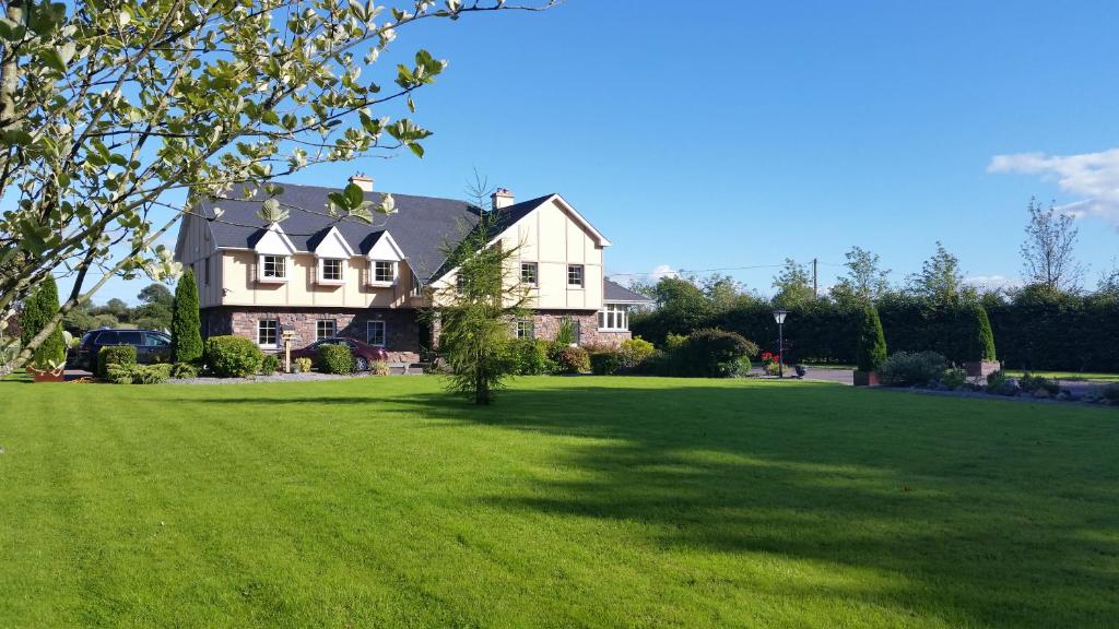 卡斯莱兰Cloghan Lodge的大型房屋,设有大型绿色草坪