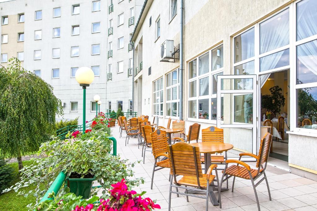 普热梅希尔阿克德米亚酒店的一座带桌椅的庭院和一座建筑