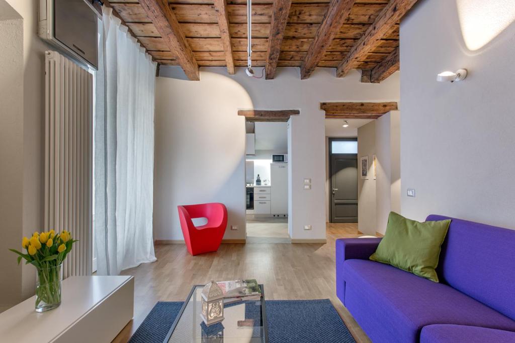 贝加莫科尔特维奇亚2.0公寓的客厅配有紫色沙发和红色椅子