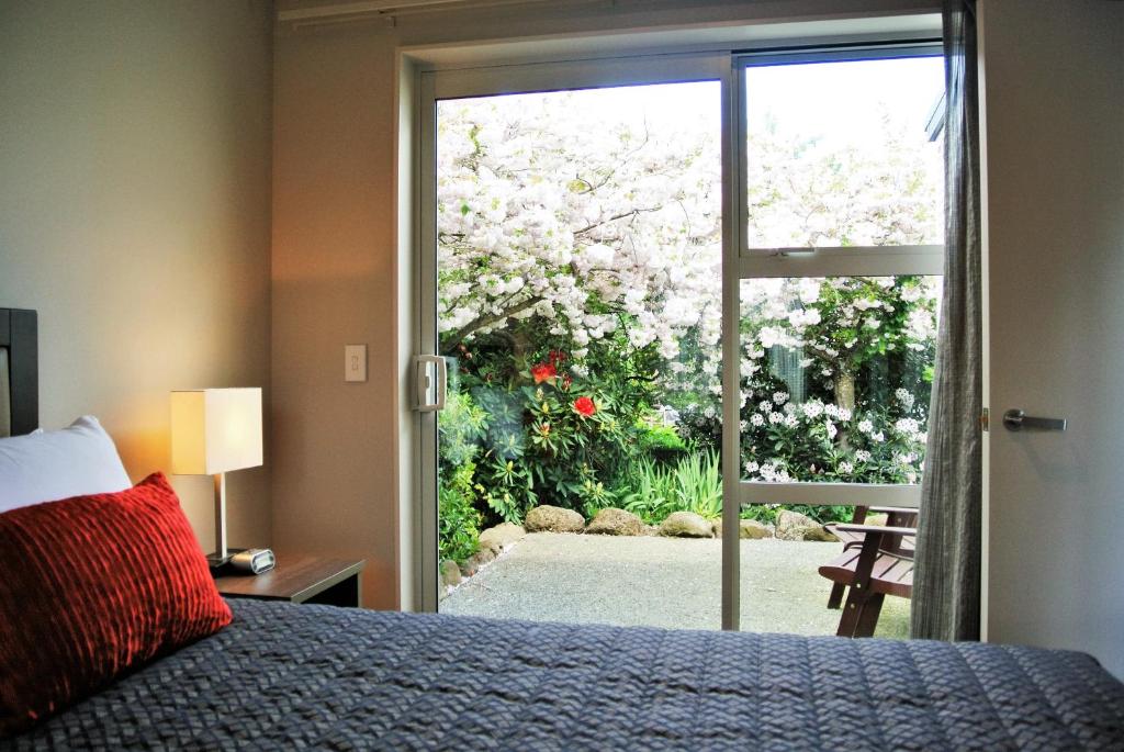 Oxford牛津汽车旅馆的一间卧室设有一张床,并有一扇通往花园的门