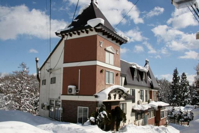 白马村明日香旅馆的一座大建筑,有雪盖屋顶