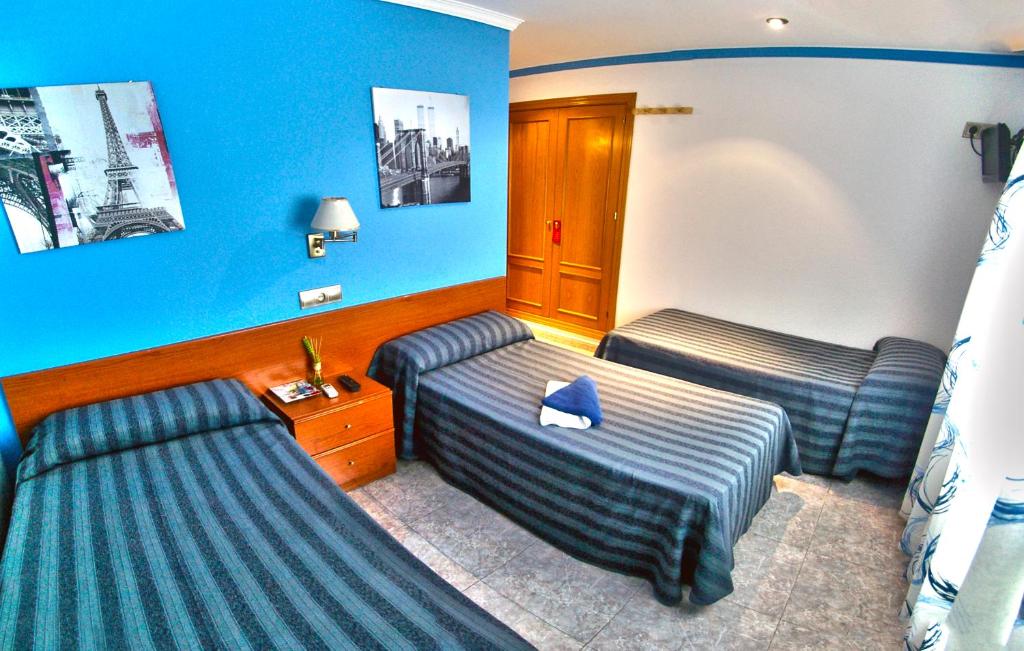 圣达菲阿波罗瑞斯旅舍的酒店客房,设有两张床和蓝色的墙壁