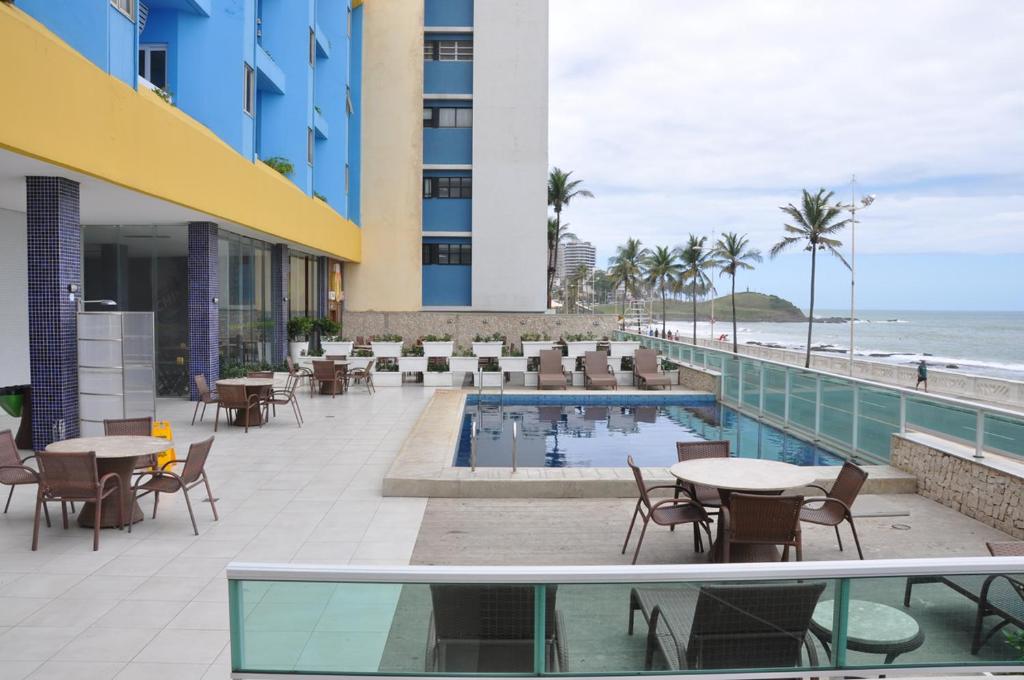 萨尔瓦多Bahia Flat ap 206的酒店带桌椅的庭院和海滩