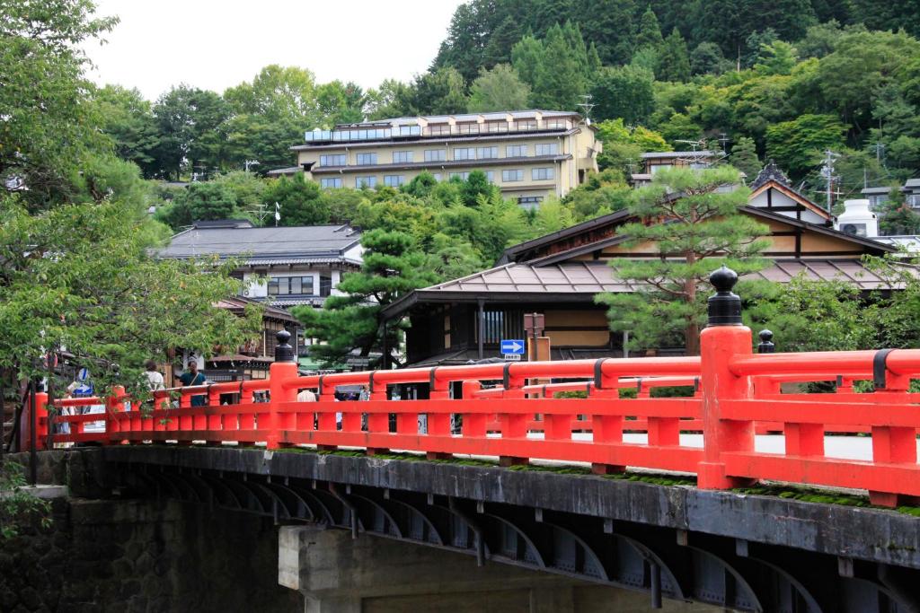 高山火沙卡库酒店的一座以建筑为背景的红桥