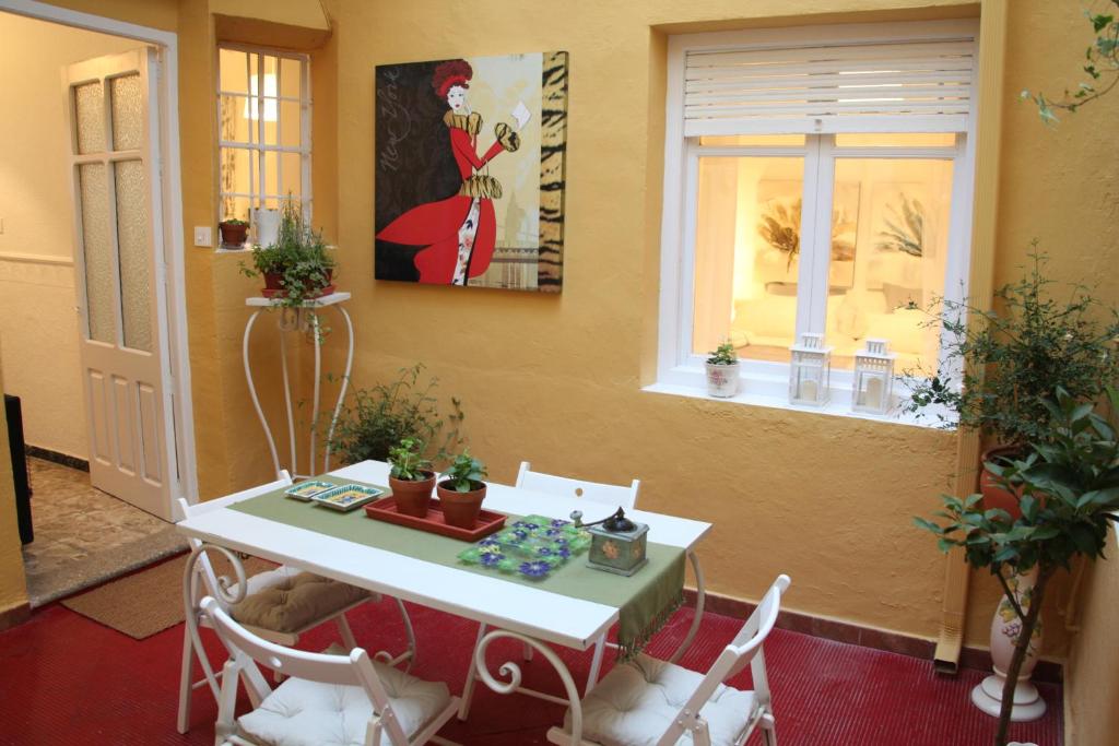 比列纳Casa Jazmín的配有桌椅和绘画的房间