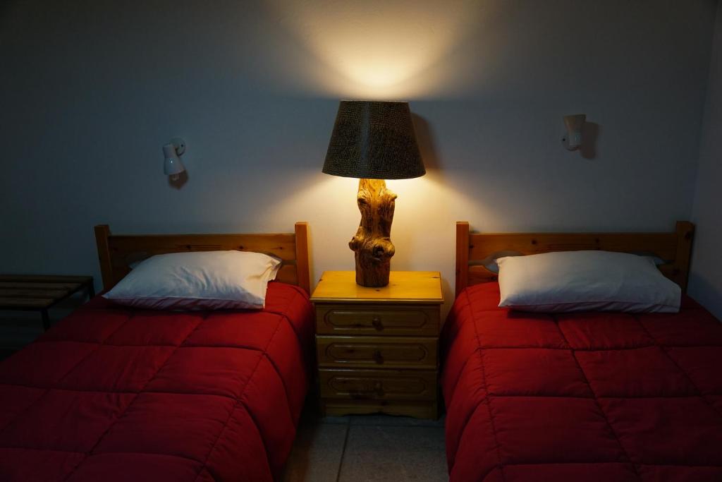 卢特拉伊帕蒂斯Elatos的一间卧室配有两张床和床头灯。