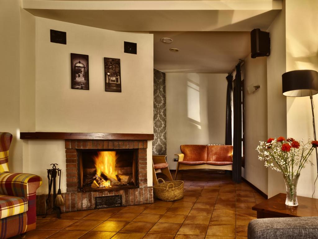 洛阿雷洛阿雷霍斯佩德里亚酒店的客厅设有壁炉和沙发。