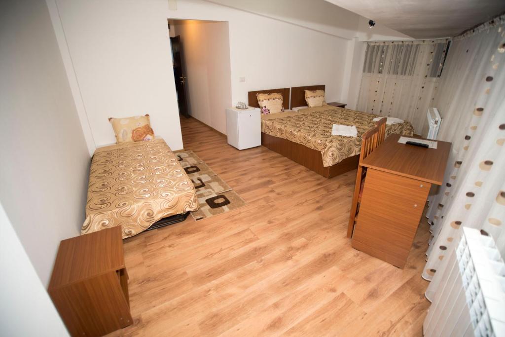 福克沙尼Hostel Ruxandra的小房间设有两张床,铺有木地板