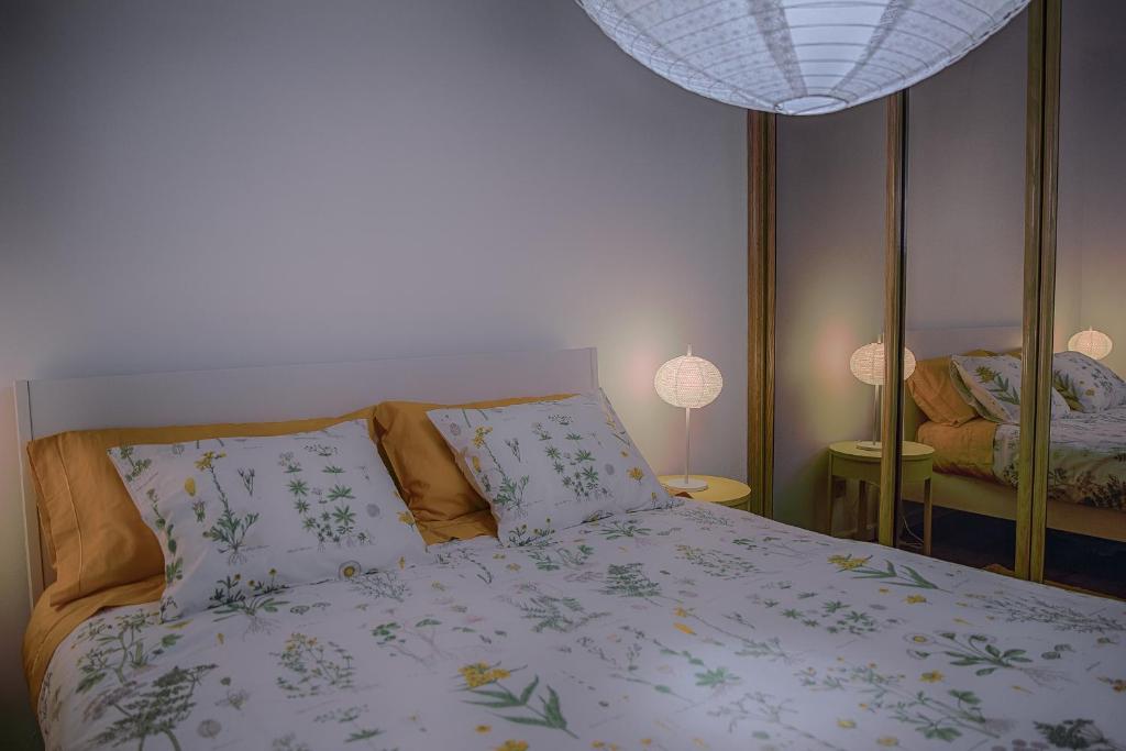 AgudaApeadeiro do Mar的一间卧室配有一张带两个枕头和镜子的床
