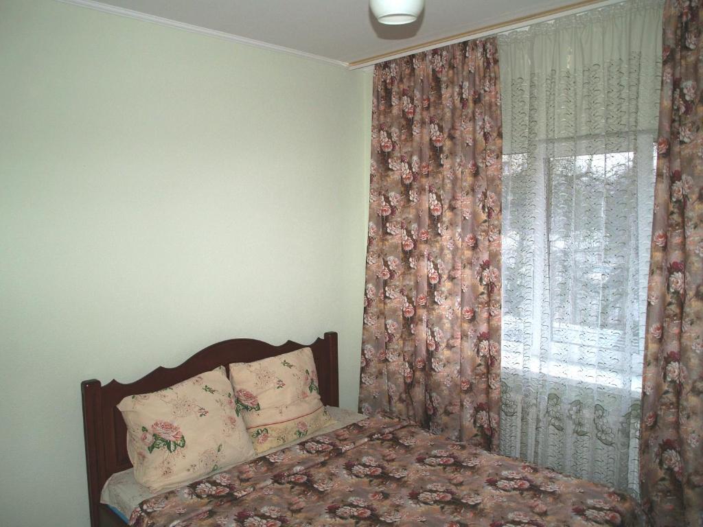 利沃夫Apartament Sanitarna 17的一间卧室配有床和带窗帘的窗户