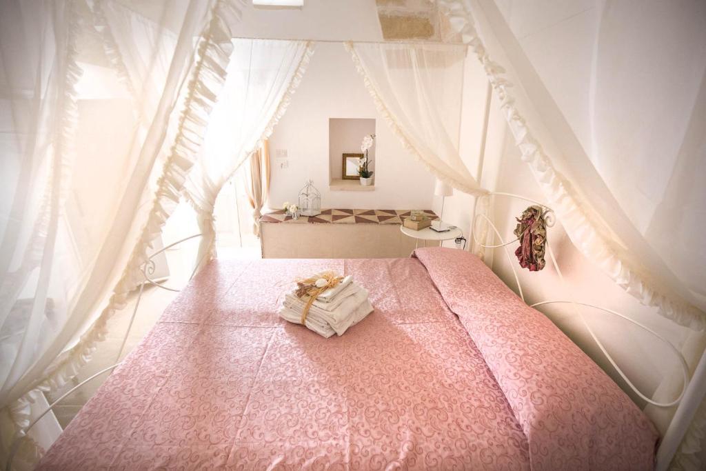 波贾尔多Il Borgo的一间卧室配有一张粉红色的床和天蓬