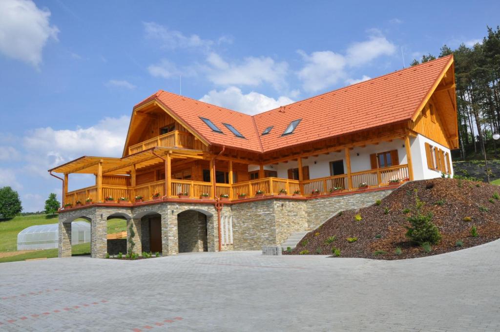 FelsőszölnökSzlovén Mintagazdaság的一座大型木房子,设有红色屋顶