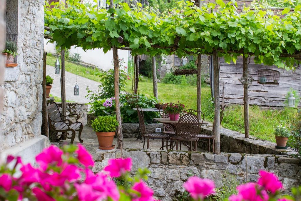GrimaccoCasa Sittaro的庭院配有桌椅和鲜花