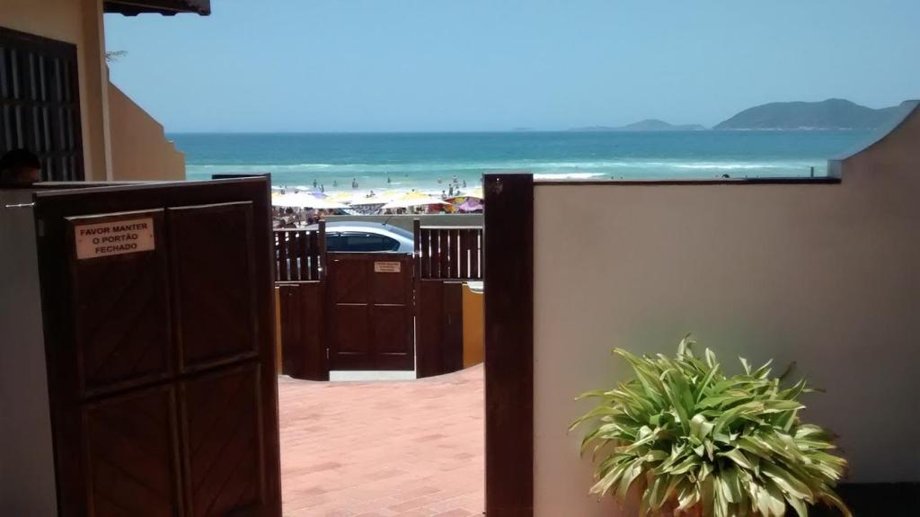 卡波布里奥Apart Hotel Praia do Pero的酒店的客房带有门,享有海滩美景。