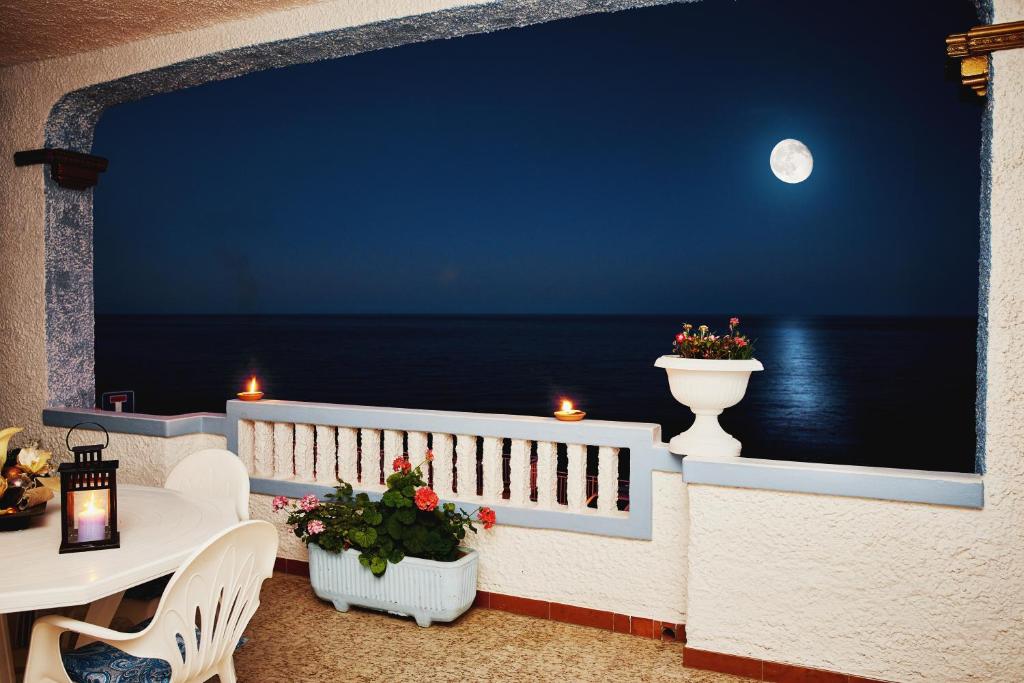 卡拉古诺内B&B AcquaDolce的阳台享有大海的美景,晚上