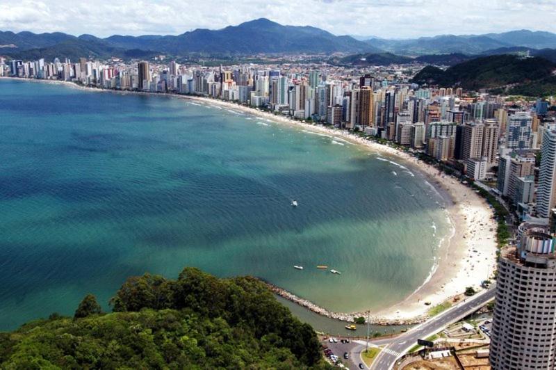 巴拉奈里奥-坎布里乌Apartamento Coral - 1 quadra do Mar的享有城市和海滩的空中景致