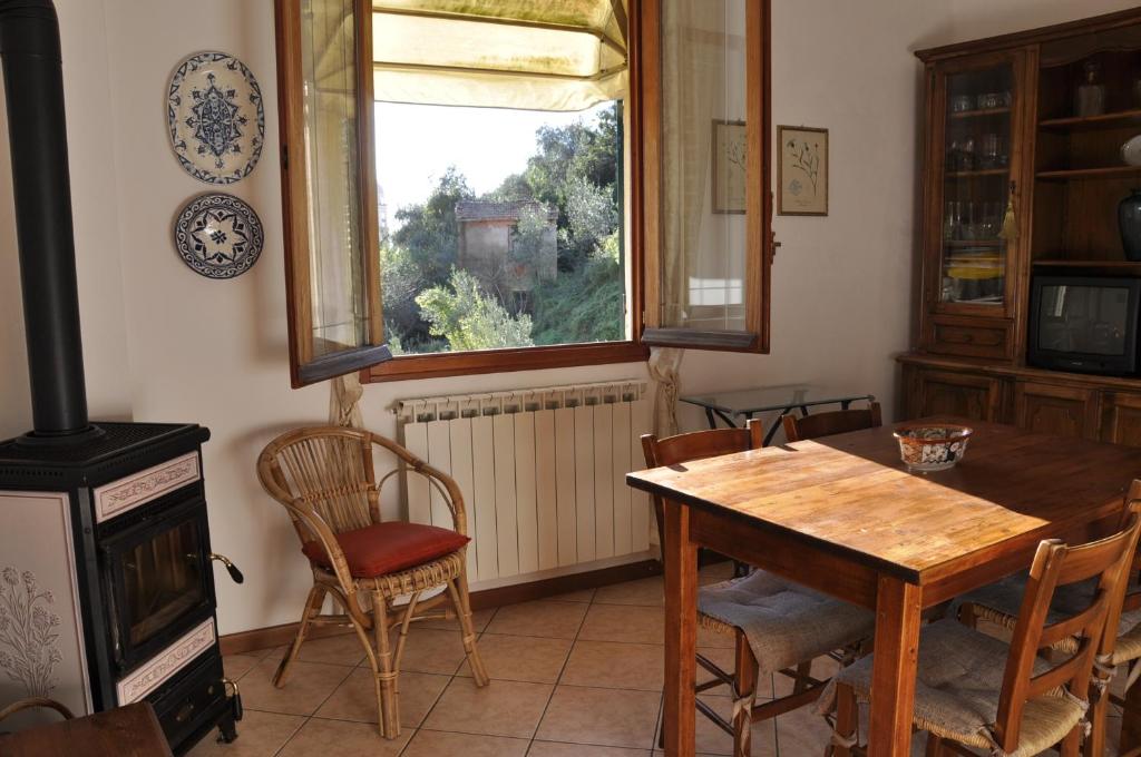 莫内利亚Casa dell'ulivo的一间带桌子和窗户的用餐室