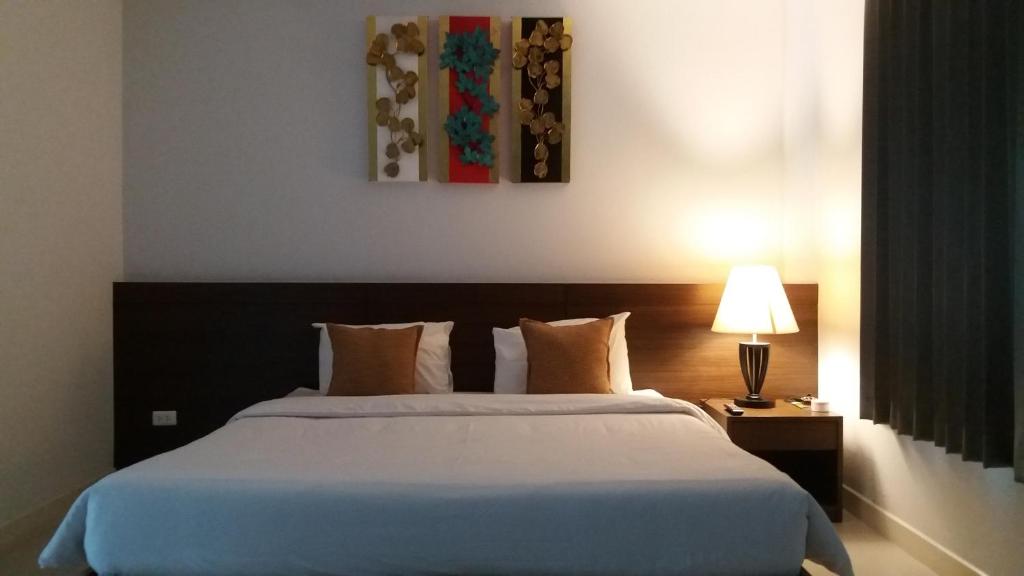 班巴克洛普吉岛温室公寓式酒店的卧室配有白色大床和灯