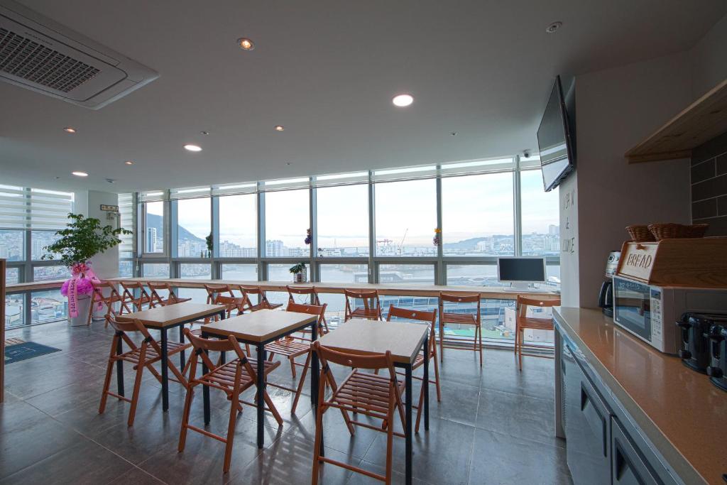 釜山南浦1高级K-旅馆的厨房设有长条吧台、凳子和桌子