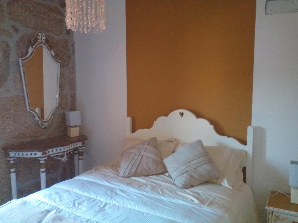 贝尔蒙特Casa Marias的卧室配有一张带镜子的白色床