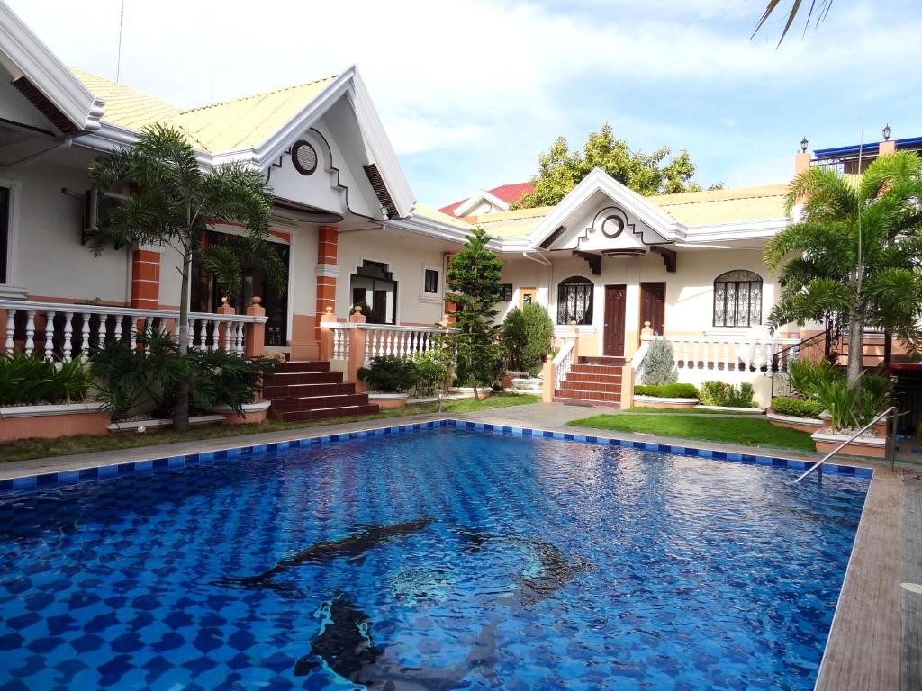 达沃市行政别墅套房旅馆的房屋前有游泳池的房子