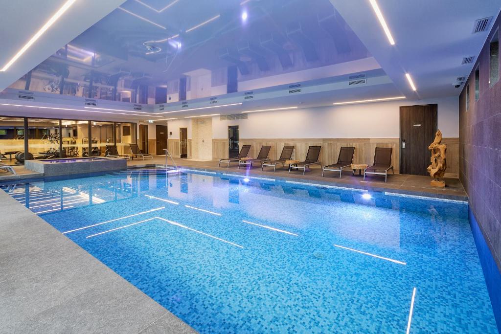 布雷达Van der Valk Hotel Breda的大楼内一个蓝色的大型游泳池