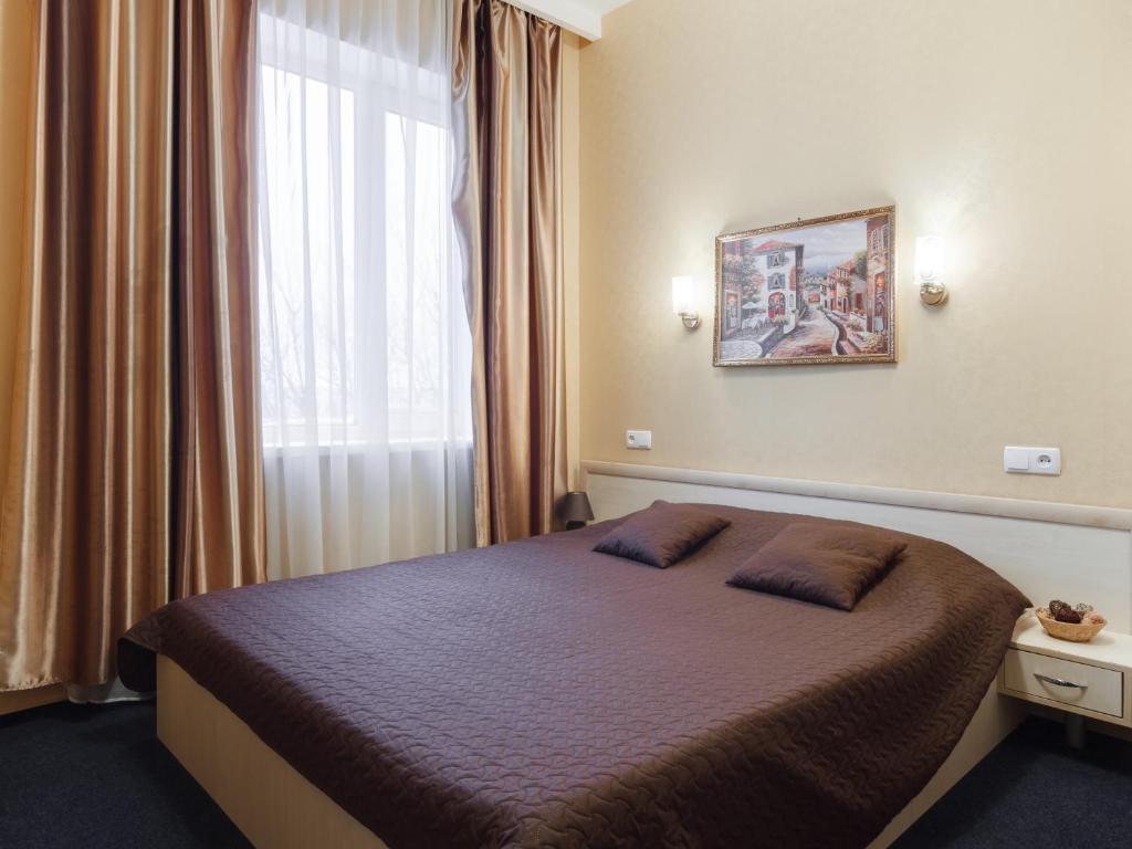 哈尔科夫阿索特尔酒店的一间卧室设有一张大床和窗户