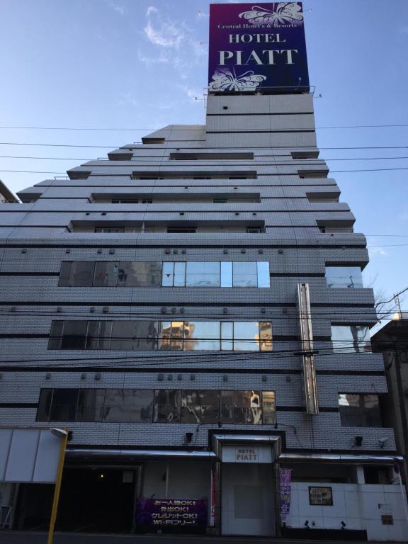 名古屋派亚特酒店（仅限成人）的一座高大的建筑,上面有标志