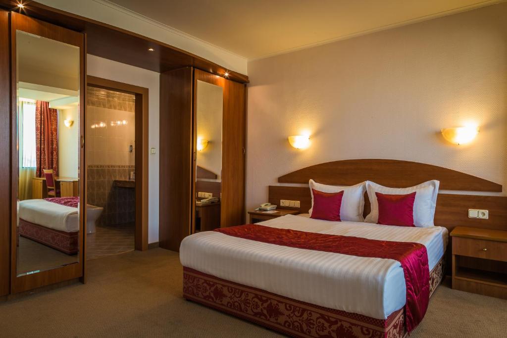 塞夫利耶沃塞弗利夫广场酒店的酒店客房配有一张带粉红色枕头的大床