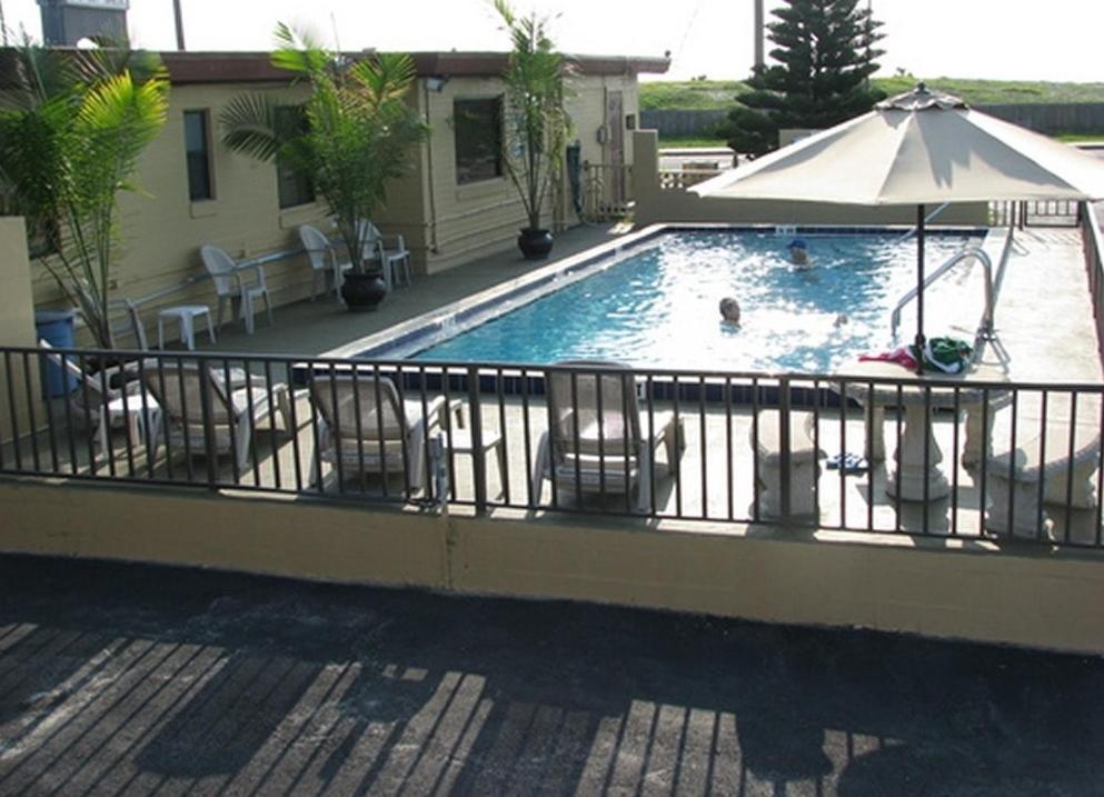 代托纳海滩大西洋经济酒店的一个带椅子和遮阳伞的游泳池