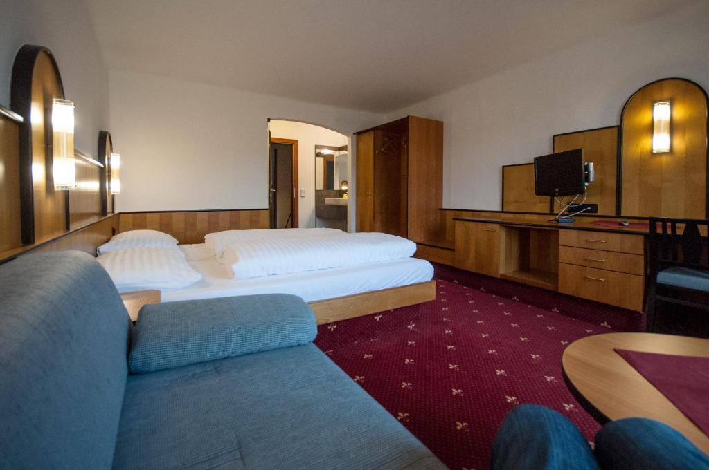 多瑙河畔阿沙赫盖斯特豪弗索尼酒店的酒店客房,设有两张床和一张沙发
