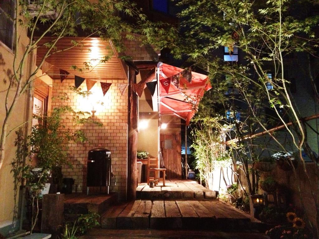 广岛广岛上佳旅馆 的一间小房子,晚上设有木门廊